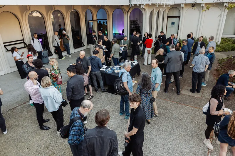 A wide view of the outdoor arrival crowd before April Film Club.
