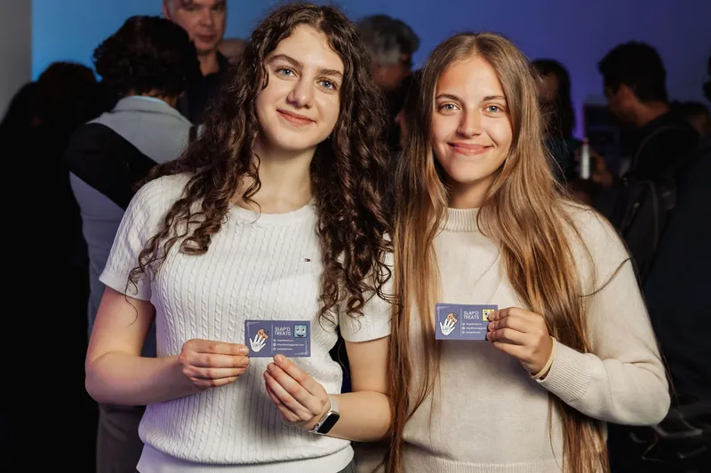 Two attendees smiling together near the end of the gathering.