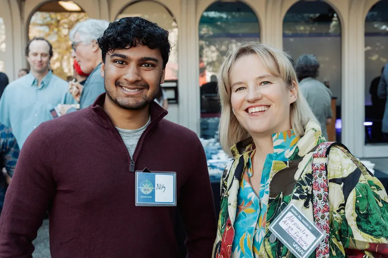 Two community members posing together in the courtyard.