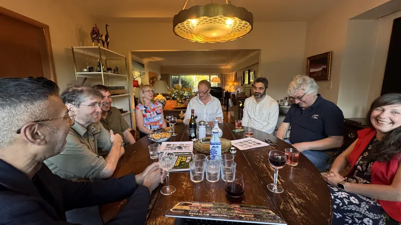 The table in session, wine and notes on the wood.