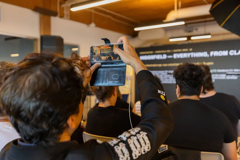 Audience listening and phone recording during the presentation, photo 065.
