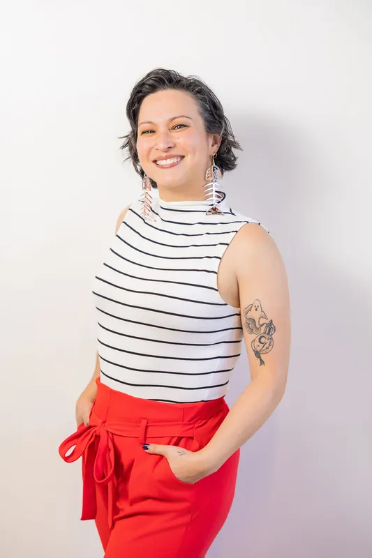 Smiling Film Club pre-event portrait in a striped top and red pants, photo 002.