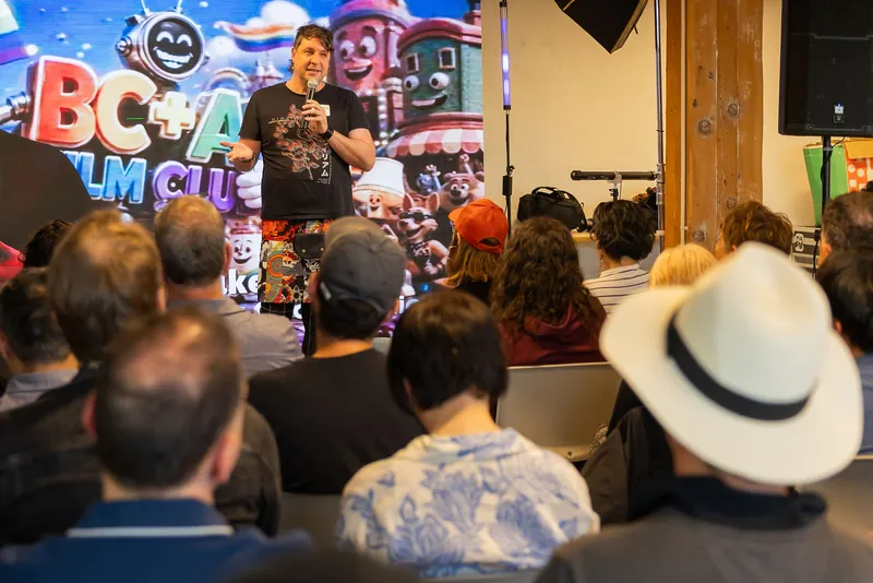 Showcase remarks and audience question in front of the Film Club screen, photo 165.