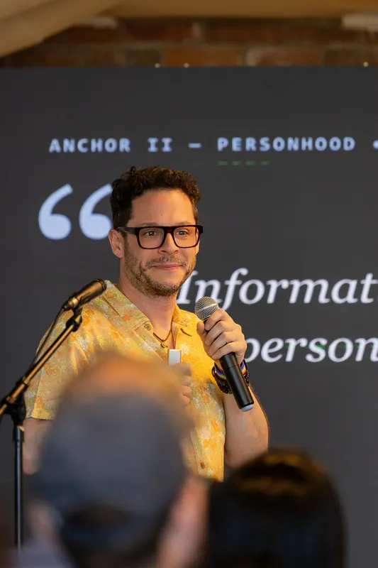 Presenter explaining a personhood slide and related technical details, photo 054.