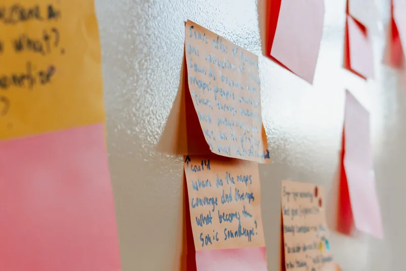 Close view of handwritten ideas gathered on colourful sticky notes, photo 097.