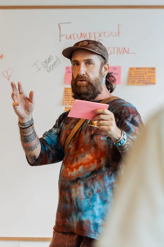 The facilitator works through ideas gathered on the workshop wall, photo 072.