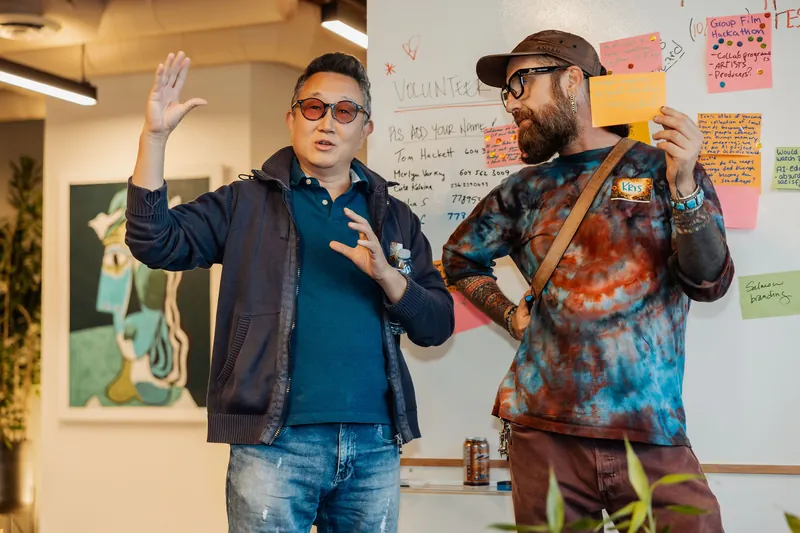 A participant makes a point while the facilitator listens, photo 137.