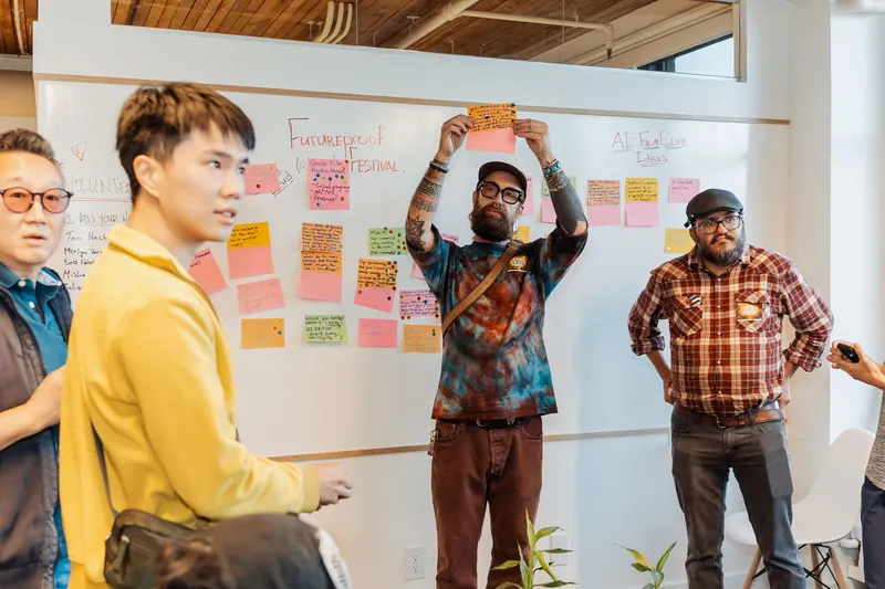 Attendees share a new note with the group at the idea wall, photo 116.