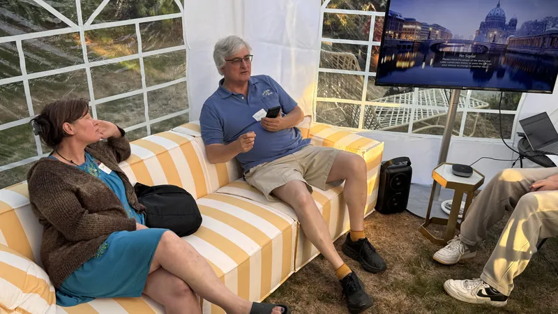 An informal sofa conversation between talks on the striped cushions.