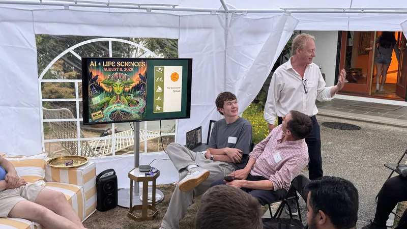 The AI + Life Sciences August 11 slide on screen in the backyard tent.