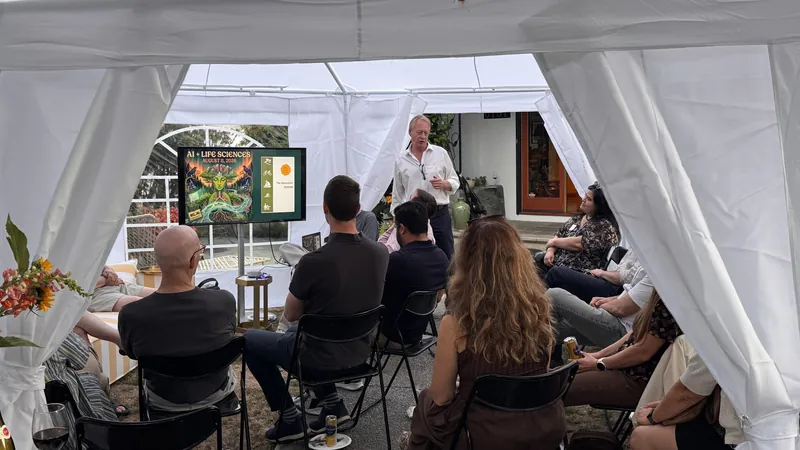Audience watching the Life Sciences presentation from mid-tent.