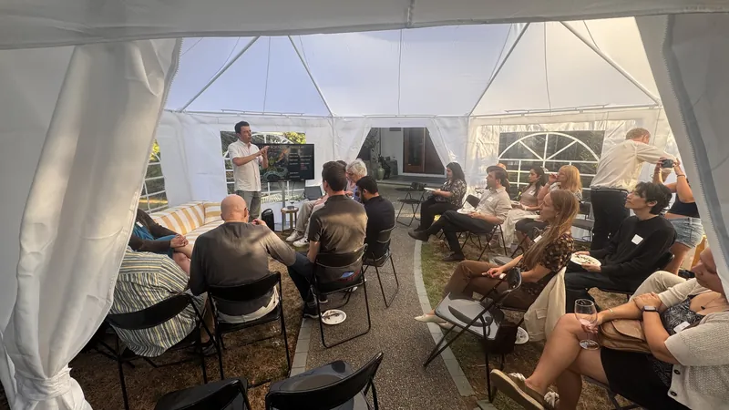 Guests listening to a short talk inside the tent.
