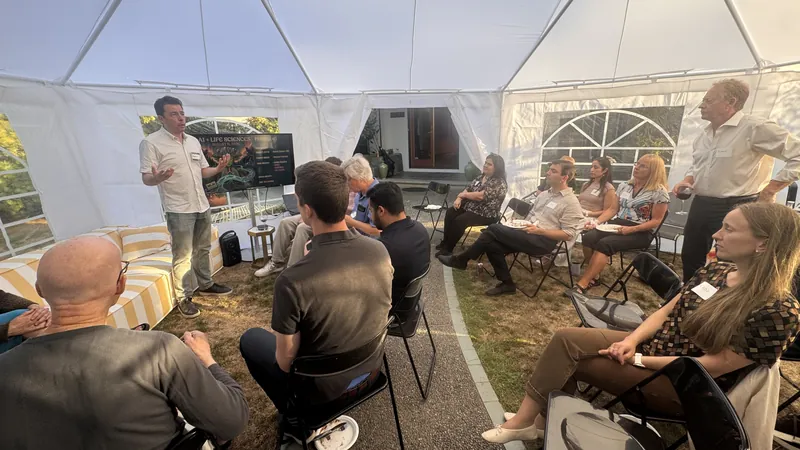 Guests facing the front of the tent during a talk.
