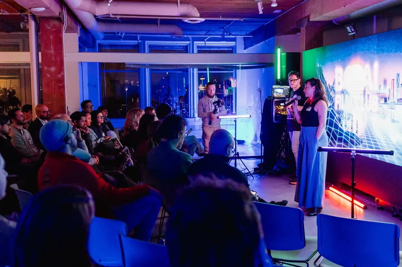 A presenter speaking to a full room during the March Film Club session.