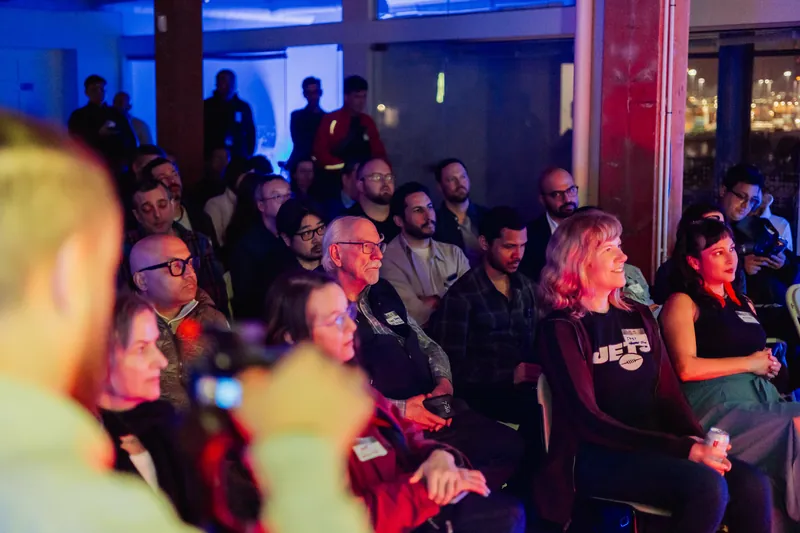 Audience members watching the stage during a March Film Club presentation.
