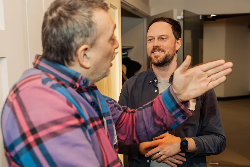 Two attendees deep in conversation at the March Film Club meetup.