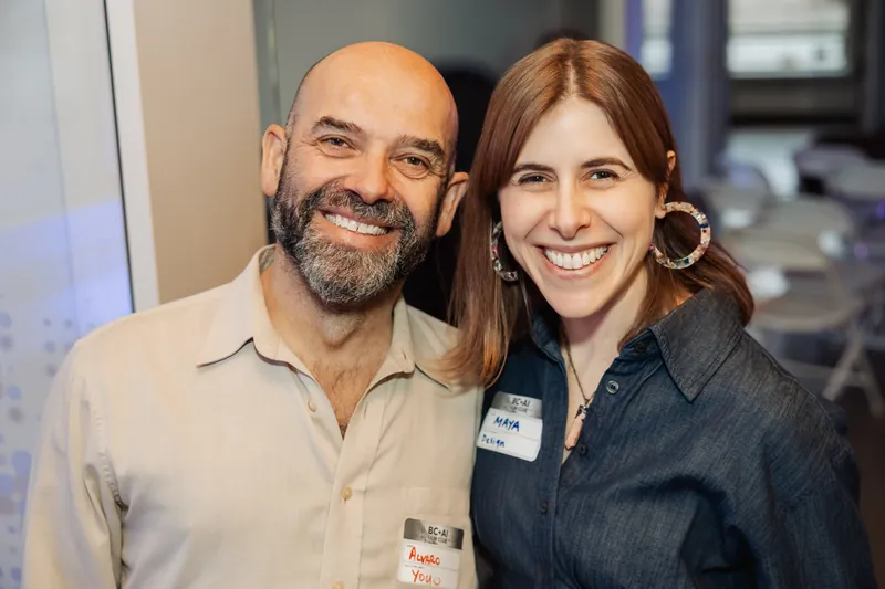 Two Film Club attendees smiling during the pre-show gathering.