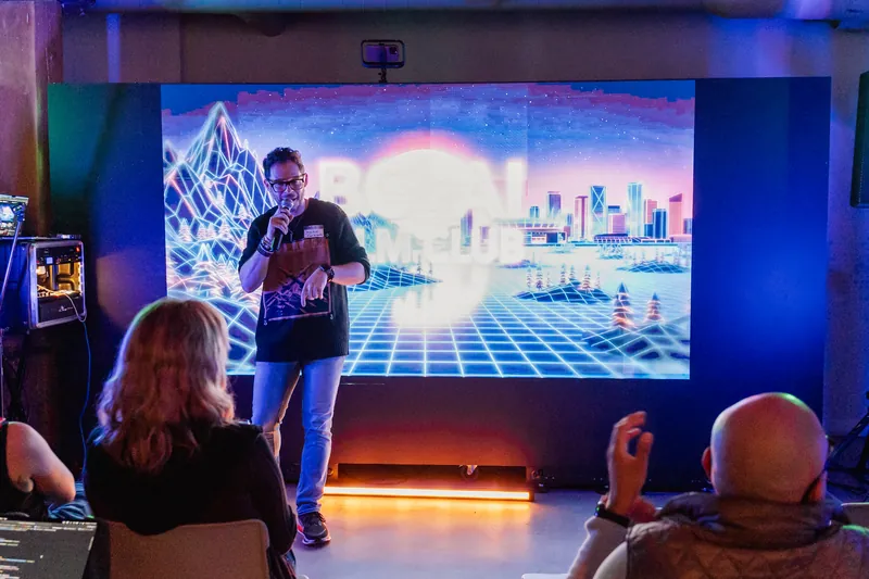 A closing presentation moment in front of the BC + AI Film Club screen.
