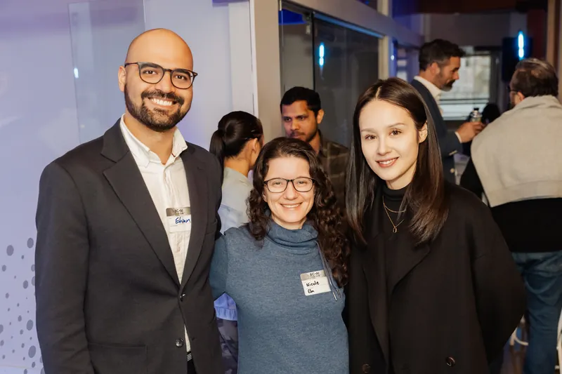A trio of attendees smiling during the March Film Club gathering.