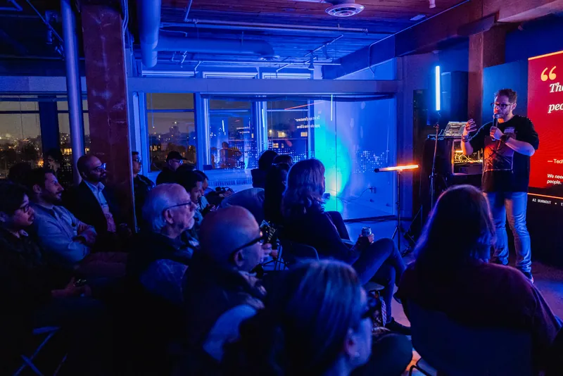 The audience watching a presenter and projected slides during Film Club.