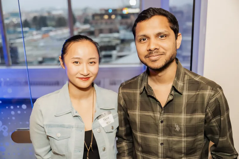 Two Film Club attendees posing together with Vancouver visible behind them.