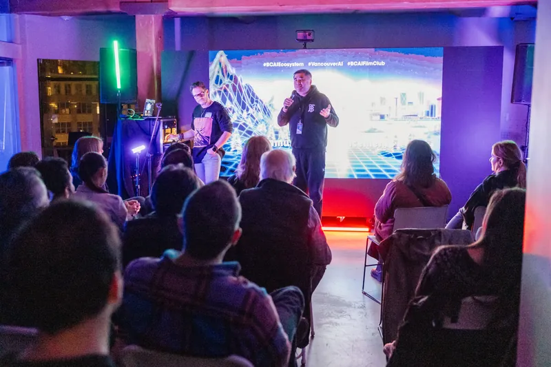 A wide shot of presenters and audience during the March session.
