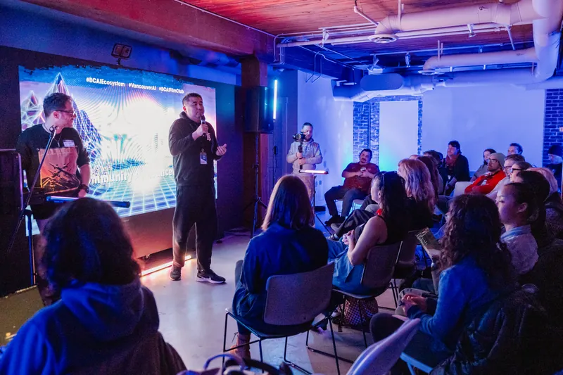 Presenters addressing the audience in front of a projected image.