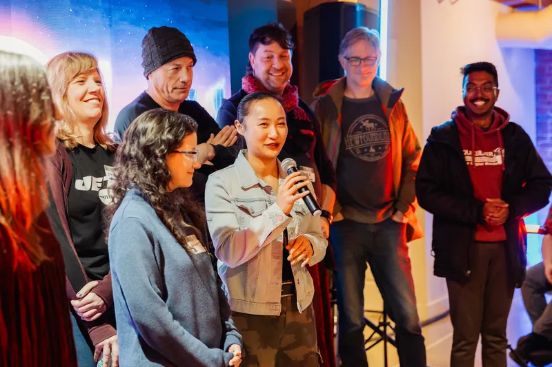 An attendee speaking into a microphone during a group share-out.