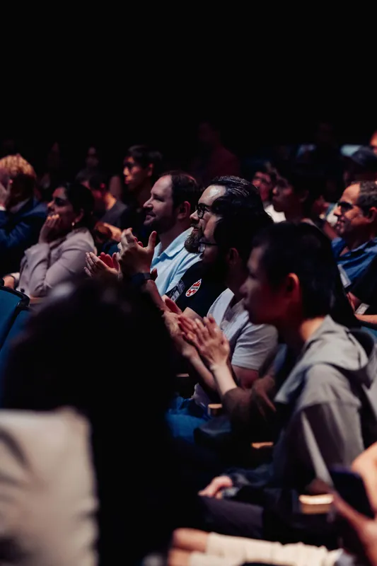 Audience members applaud during the indoor program under the Space Centre planetarium dome.