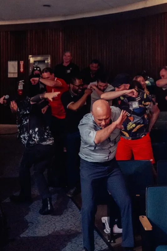 Participants mirror each other's arm movements in a wave of synchronized play during the interactive interlude.