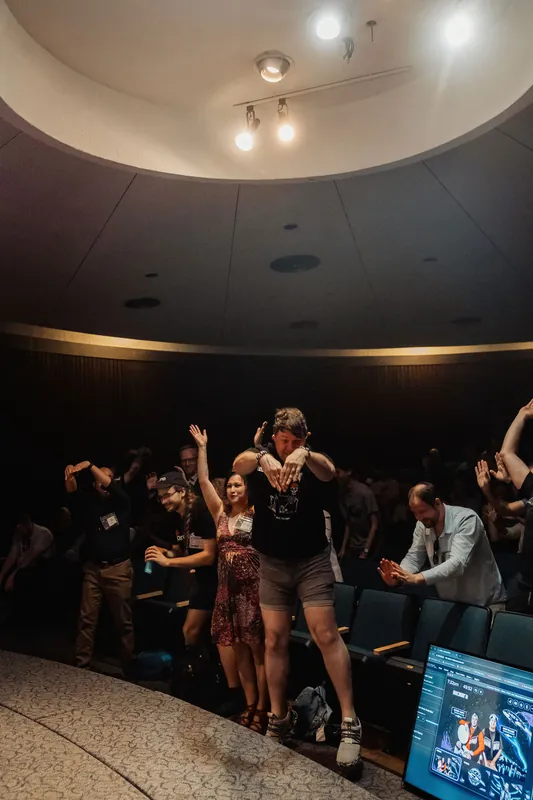 The Space Centre planetarium erupts as attendees spring to their feet during a high-energy interactive moment.