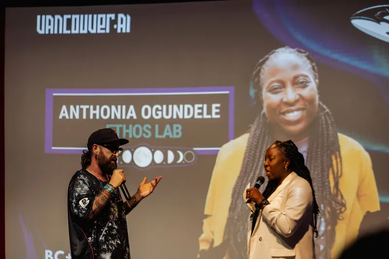 The host introduces Anthonia Ogundele of Ethos Lab as her speaker card appears on the Vancouver AI projection screen.