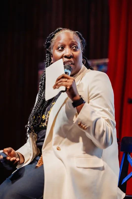 Anthonia Ogundele glances to the side with wide-eyed emphasis while delivering a key moment in her talk.