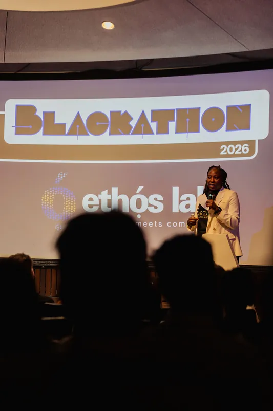 A Blackathon 2026 and Ethos Lab slide fills the screen as a speaker addresses the darkened auditorium.
