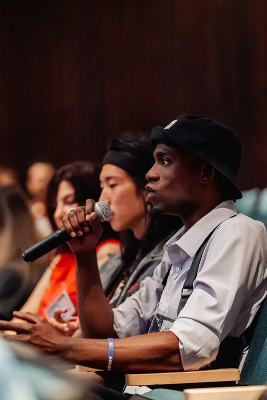 An audience member raises a microphone to pose a question during the evening program inside the Space Centre.