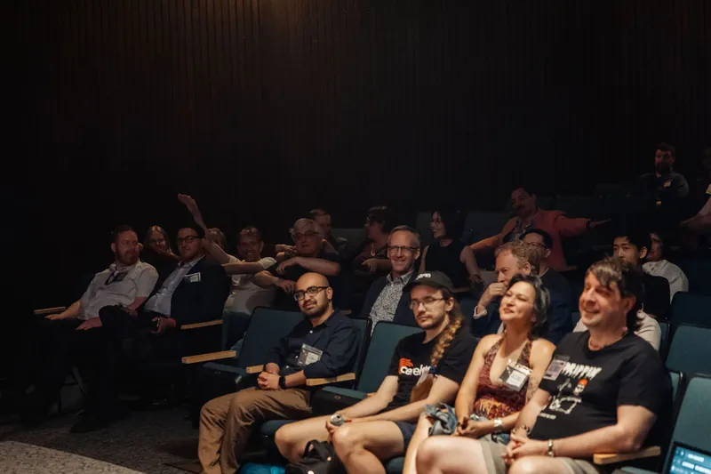 A smiling, mixed-age crowd fills the tiered seats of the H.R. MacMillan Space Centre planetarium during the evening program.