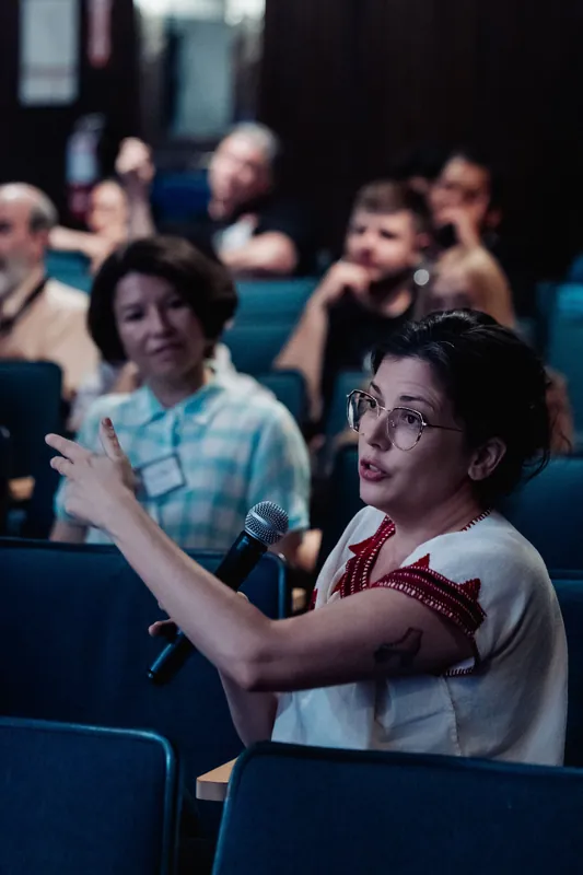 The same attendee gestures to make her point during the lively Q&A session inside the Space Centre auditorium.