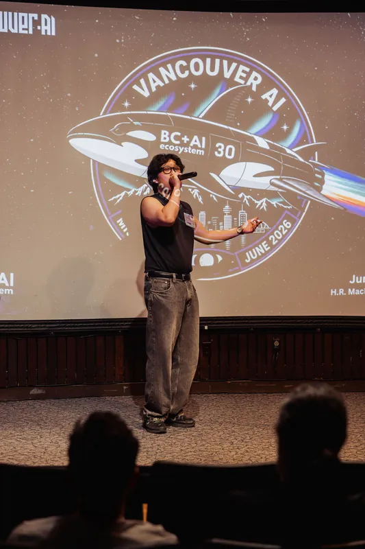 The performer holds the microphone close as the Vancouver AI Mission 30 badge fills the projection screen behind.