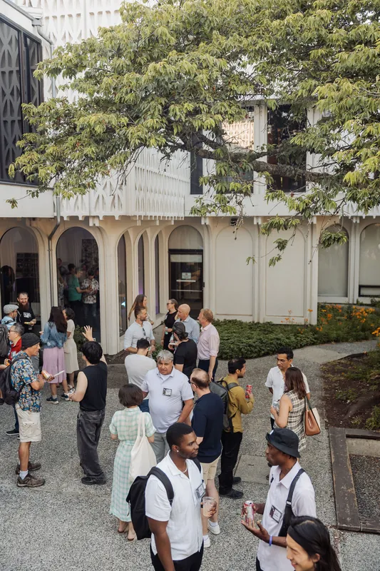 An elevated view reveals the Space Centre's colonnaded exterior framing the buzzing outdoor reception crowd.