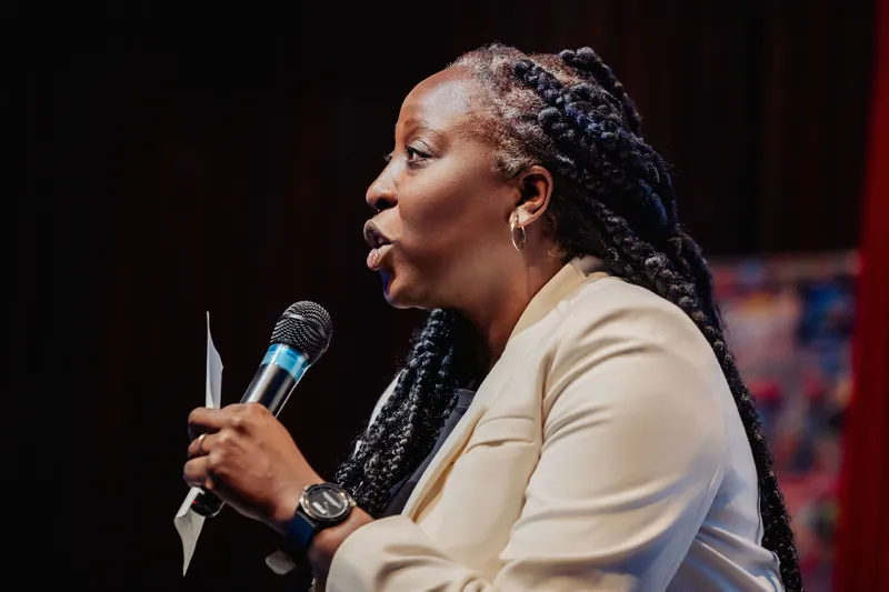 In tight profile, Anthonia Ogundele speaks into the mic with evident passion during her Ethos Lab keynote.