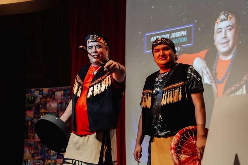 One performer points enthusiastically toward the crowd as the Squamish Nation drum duo wraps up their ceremonial set inside the dome.