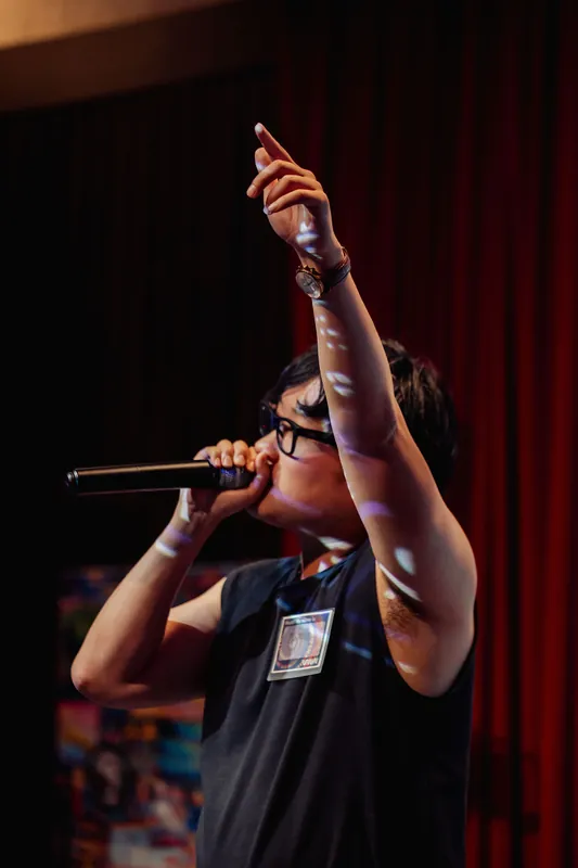 Arms wide — the room feeds off the performance.