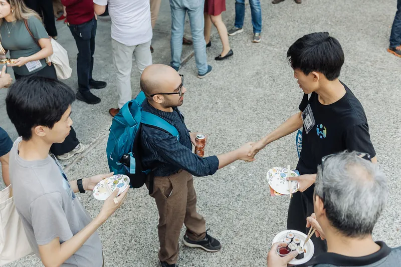 Side conversations and quick hellos before the talks.