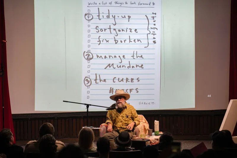 Dave Olson continues from the armchair as denser text and photo slides roll — Wider angle.