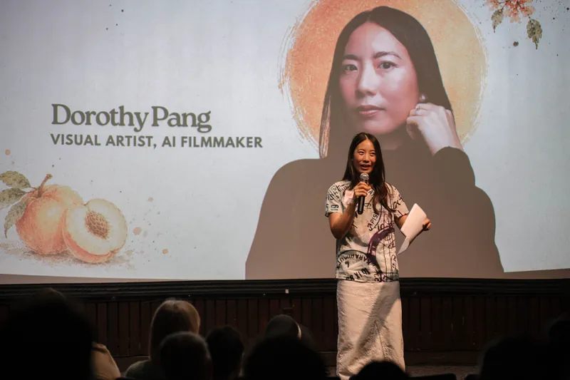 Dorothy Pang presents from the mic under her peach-illustrated intro slide — Wider angle.