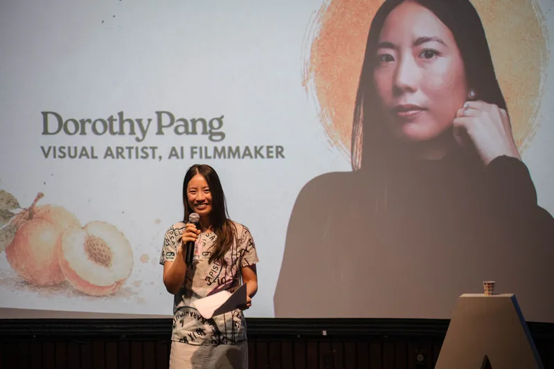 Dorothy Pang presents from the mic under her peach-illustrated intro slide — Stage-right view.
