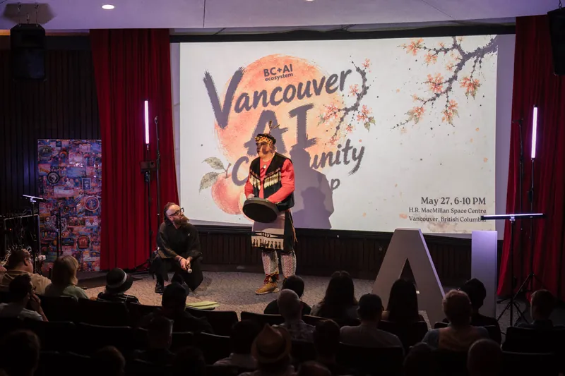 An Indigenous welcome unfolds on stage as the audience settles in — A beat later in the same beat.