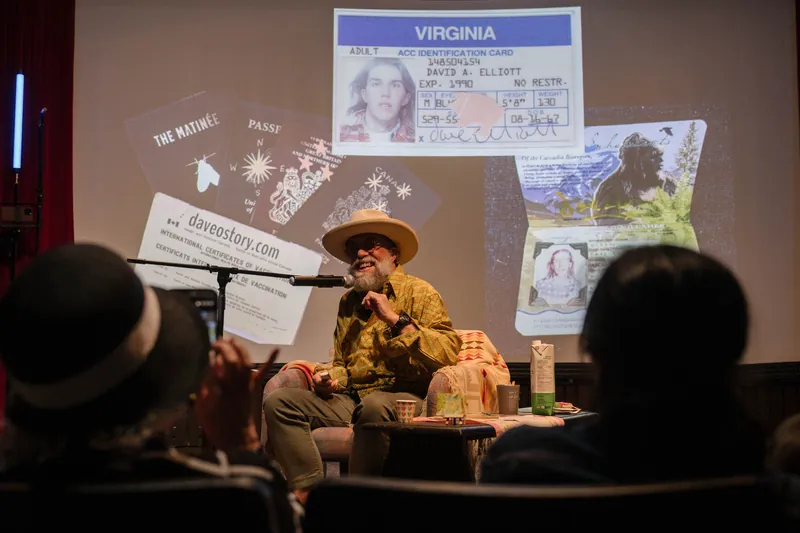 Dave Olson continues from the armchair as denser text and photo slides roll — Wider angle.