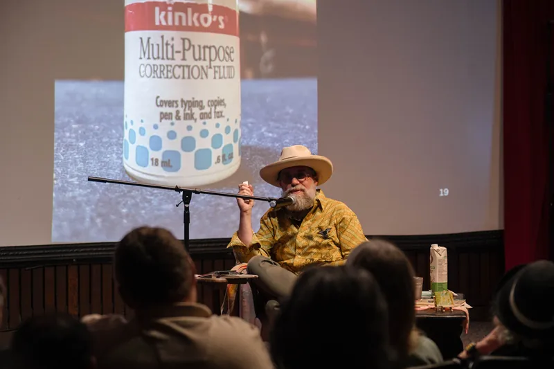 Dave Olson's slides dig into library work, notebooks, and found objects — Screen bright in the background.