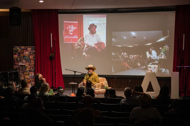 An on-stage conversation with Dave Olson — two chairs, mic, and a listening room — A beat later in the same beat.